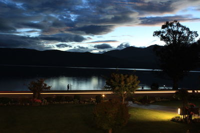 Scenic view of mountains against cloudy sky at dusk
