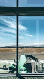 Airplane on runway against sky