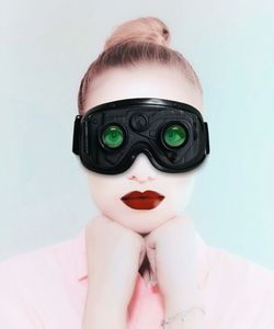 Portrait of woman wearing mask against white background