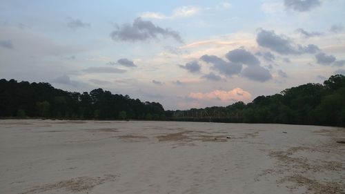 Scenic view of beach against sky during sunset