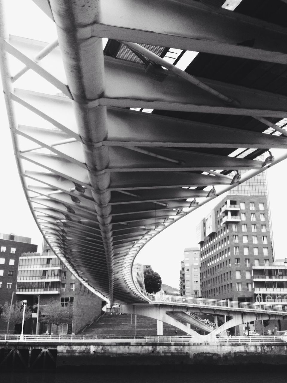 architecture, built structure, building exterior, city, building, railing, connection, modern, bridge - man made structure, low angle view, arch, incidental people, diminishing perspective, day, residential building, city life, outdoors, engineering, office building, no people