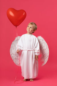 Full length of a girl holding balloons