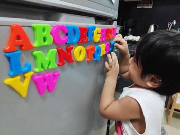 Full length of cute girl holding toy