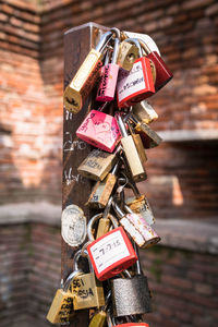 Close-up of padlocks hanging on railing