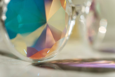 Close-up of multi colored glass on table