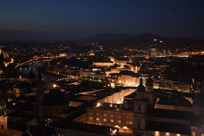 High angle view of illuminated buildings in city at night