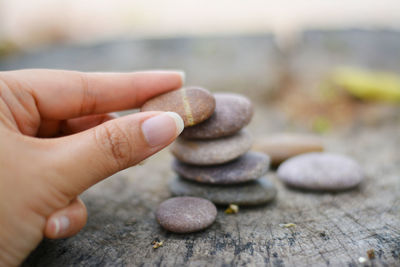 Close-up of person hand holding pebbles