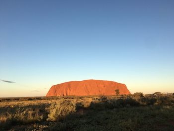 Scenic view of desert against clear blue sky