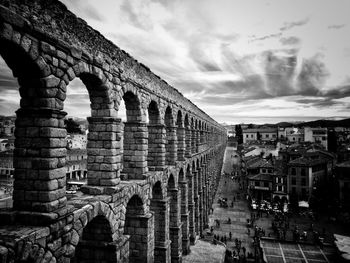 View of old bridge against cloudy sky