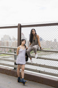 Young women posing on a bridge