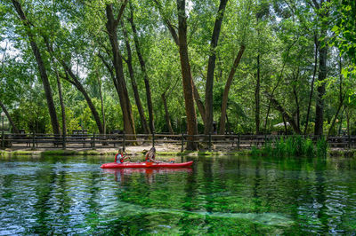 Boat in lake against trees