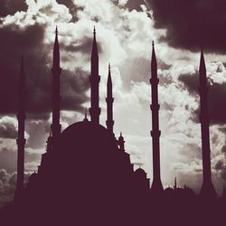 Low angle view of silhouette church against cloudy sky