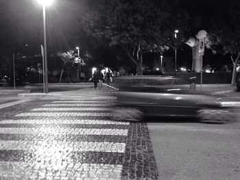 View of people walking on footpath at night