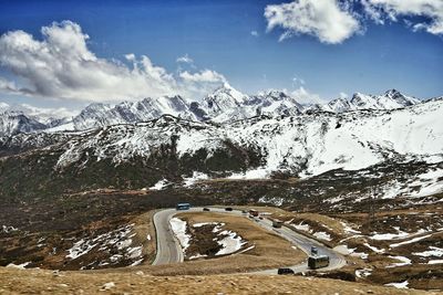 View of snow covered mountains against cloudy sky