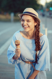 Portrait of smiling woman holding ice cream