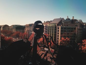 Rear view of man standing against sky during sunset