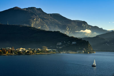 Scenic view of sea and mountains against sky