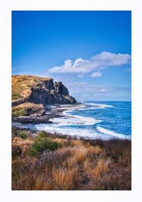 Scenic view of sea against blue sky