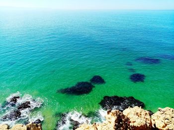 High angle view of rocks on sea shore