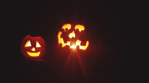 Close-up of illuminated pumpkin against black background
