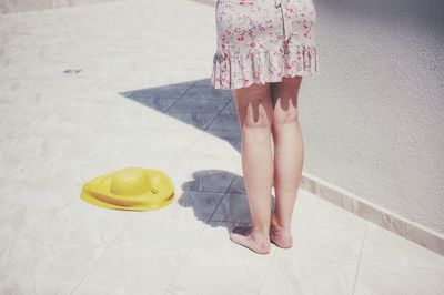 Low section of woman standing on tiled floor