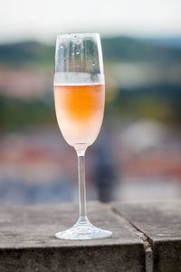 Close-up of champagne flute on retaining wall