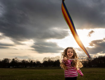 Beautiful happy little girl playing in sunlight