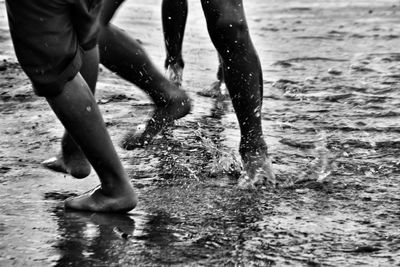 Low section of people running at beach