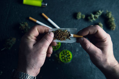 Close-up of hand holding cigarette