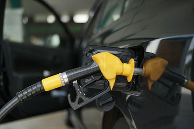 Refueling petrol into car gas tank.close up shot of petrol gun or nozzle fueling gas into car tank.