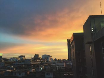 Silhouette buildings against sky during sunset