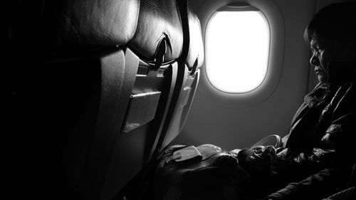 Senior man sitting in airplane