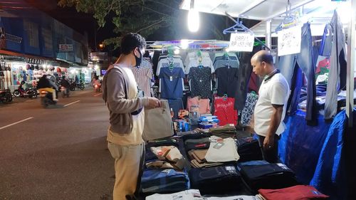 People standing on street at market stall