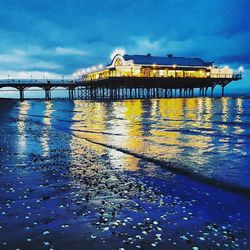 Pier over sea against blue sky