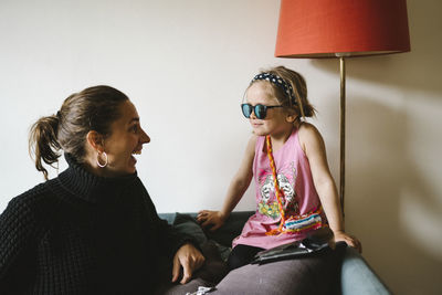 Mother with daughter on sofa