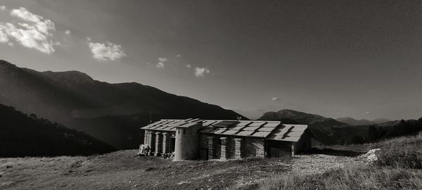 Built structure on field against sky