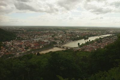 High angle view of cityscape against cloudy sky