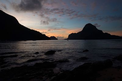 Scenic view of sea and mountains against sky