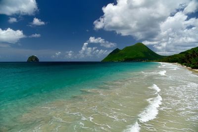 High angle view of coastline against cloudy sky