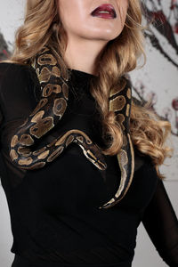 Close-up of woman holding snake