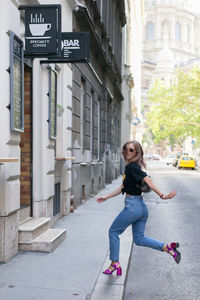 Portrait of young woman walking on street