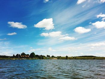 View of calm lake against cloudy sky