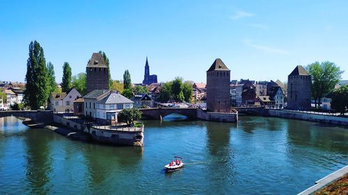 Boats in river with buildings in background