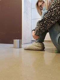 Midsection of woman standing on table