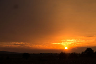 Scenic view of silhouette landscape against romantic sky at sunset