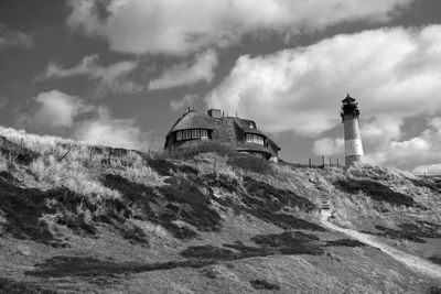 Lighthouse on mountain against sky