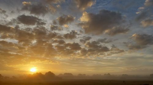 Scenic view of field against sky during sunset