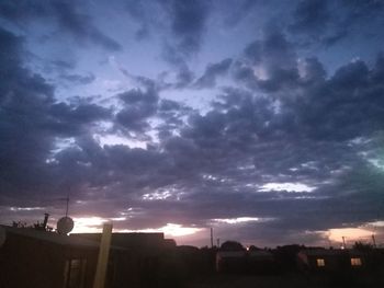 Low angle view of buildings against cloudy sky