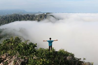 Rear view of man standing on mountain