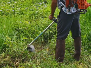 Low section of man working on field